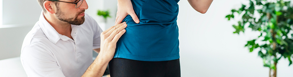 A Modern rehabilitation physiotherapy man at work with woman client working on hip